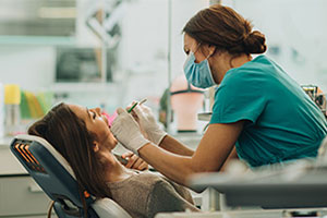 Dental assistant looking at patient