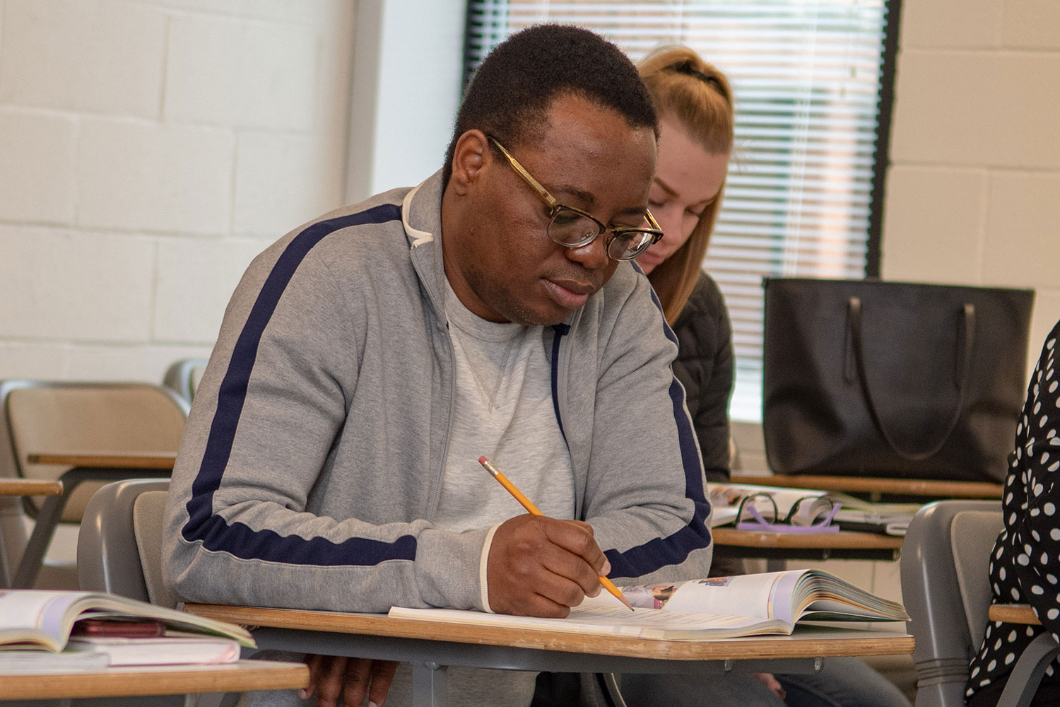 Male student focusing on workbook