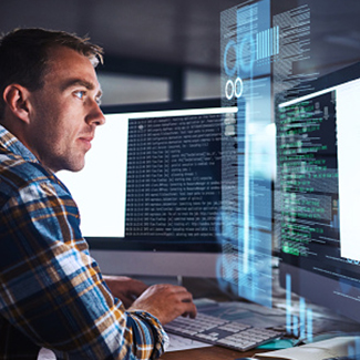 Man working on computer with multiple monitors