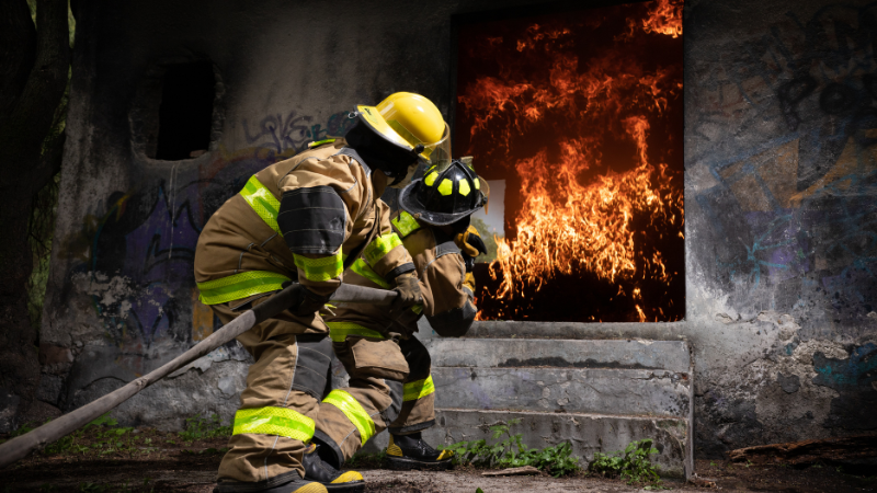 Two firefighters putting out a fire