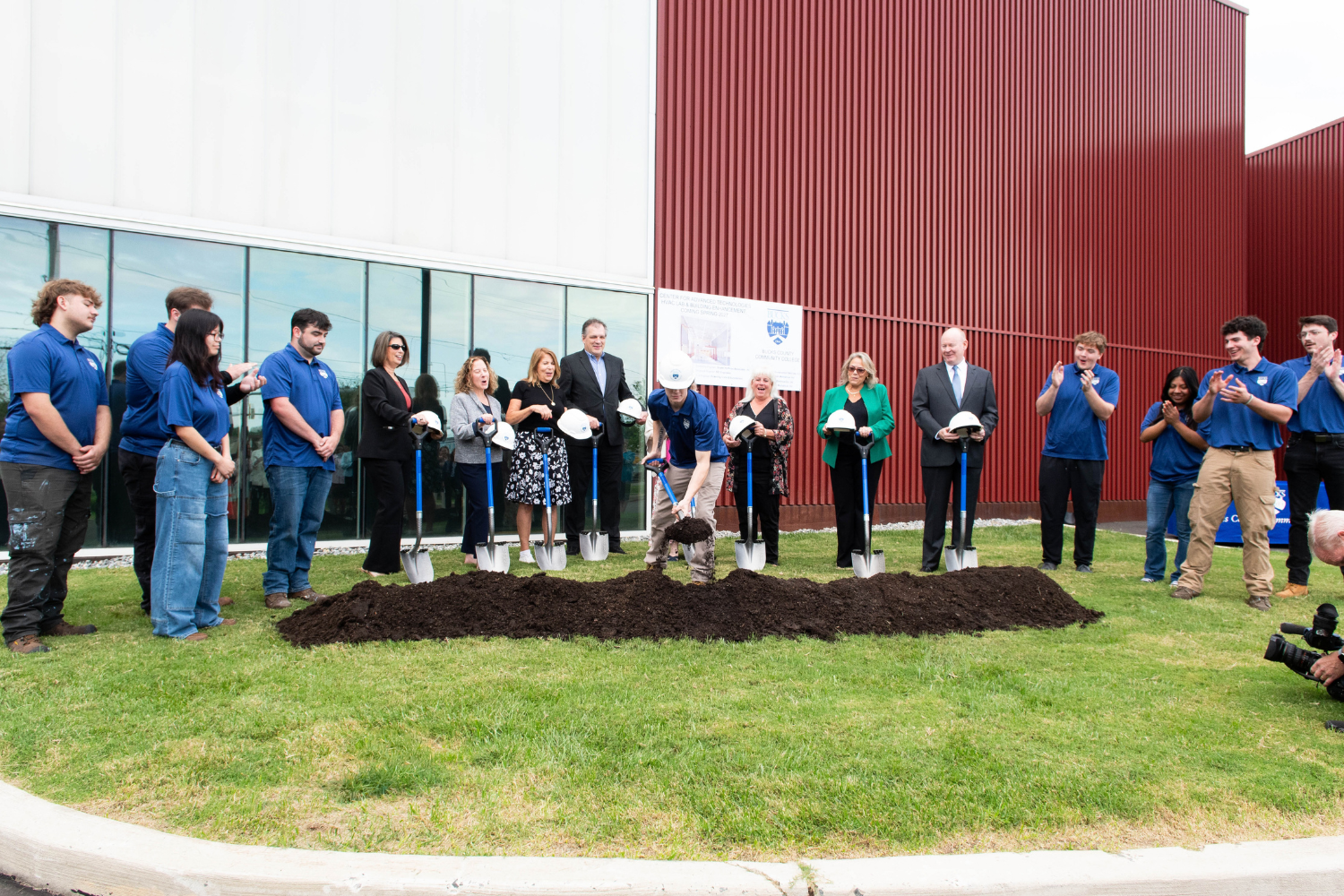 Recent graduate digging dirt for the new location for the HVAC prorgram.