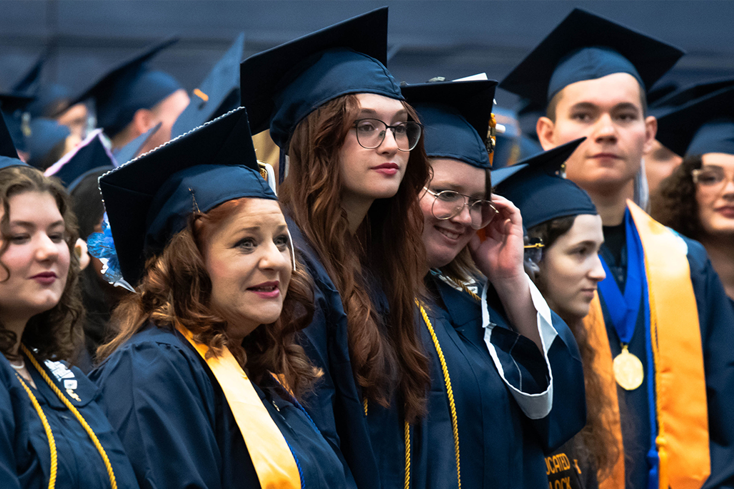 Female graduates looking toward stage