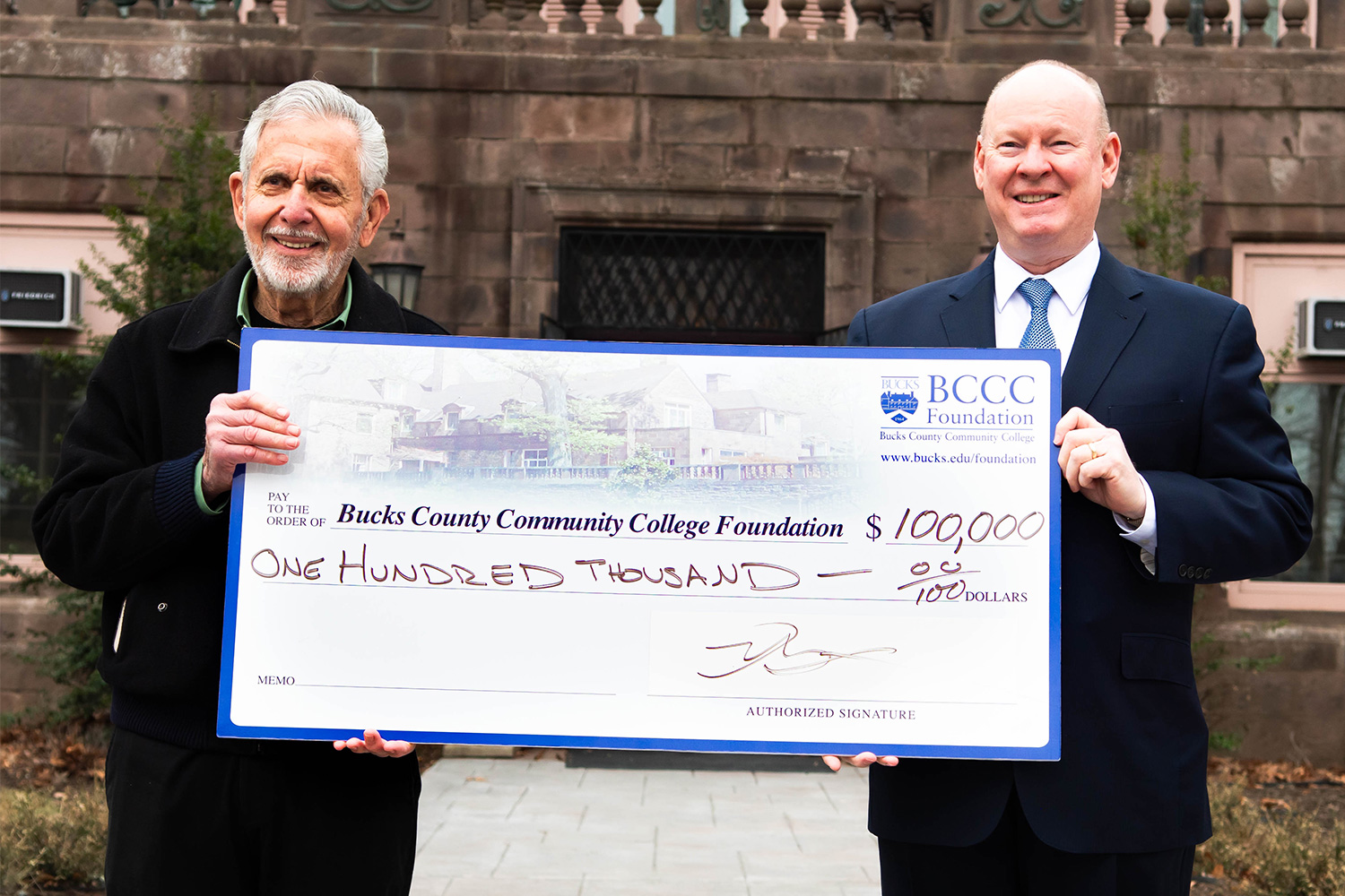 Gene Epstein and Patrick Jones holding oversized check