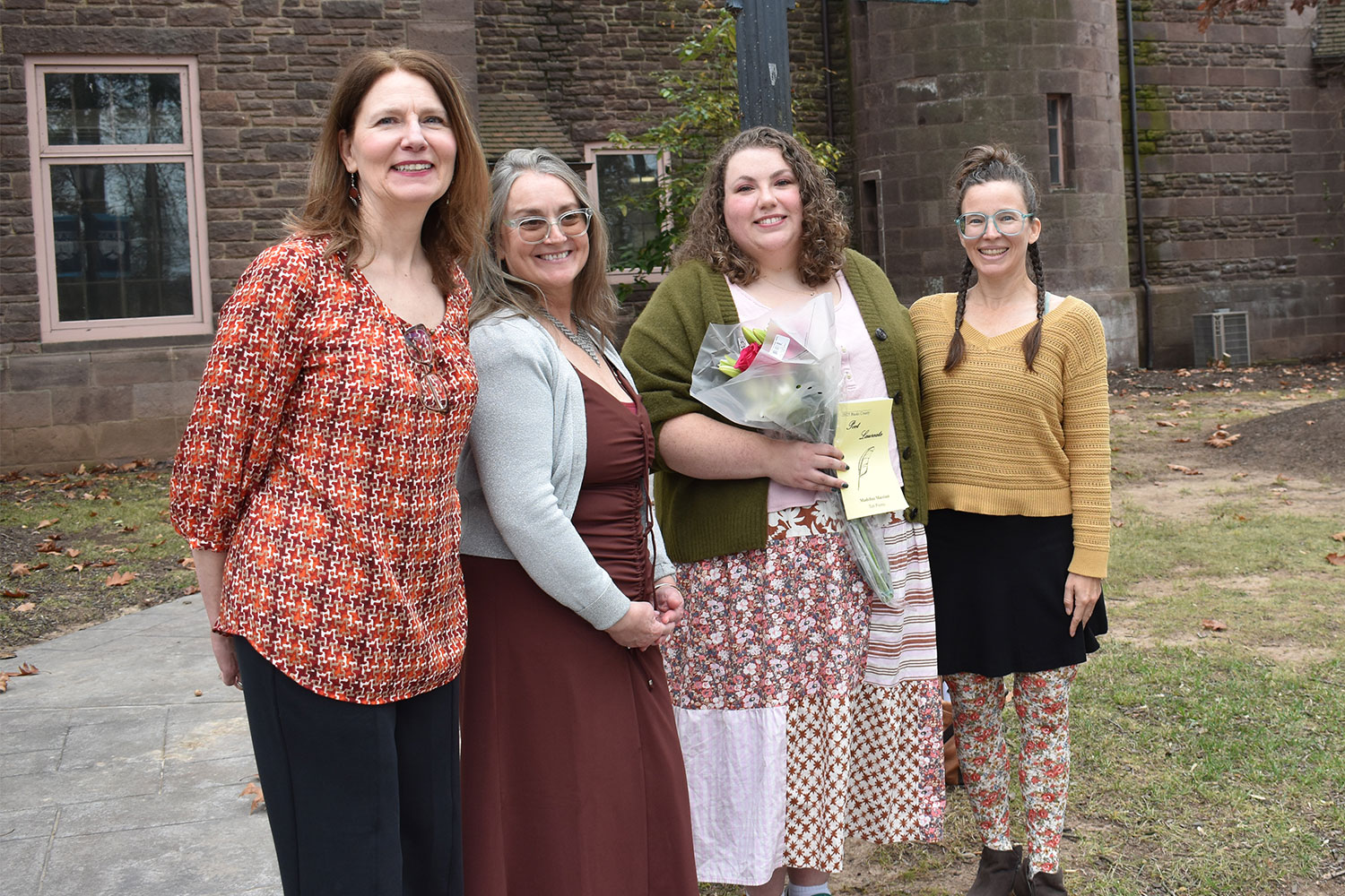 reading and reception at the College’s Newtown Campus. Pictured outside historic Tyler Hall at the 2025 reception are (left-right) runners-up Lynn Fanok and Tricia Coscia, 2025 Poet Laureate Madeline Marriott, and 2024 Poet Laureate Lake Angela.