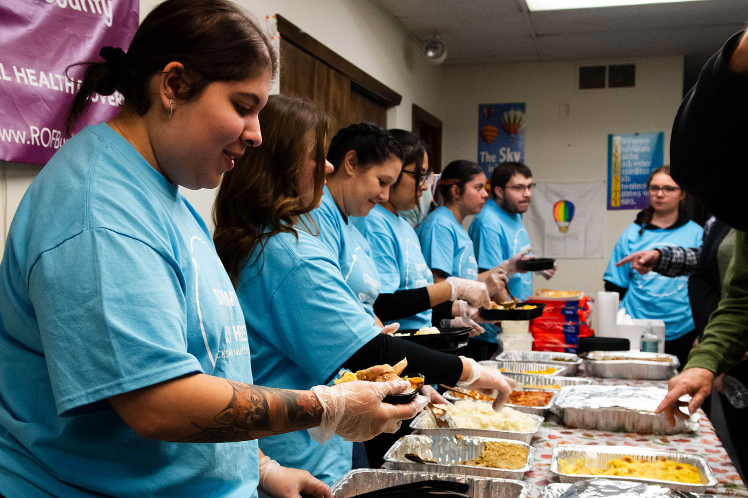 Volunteers dish out food